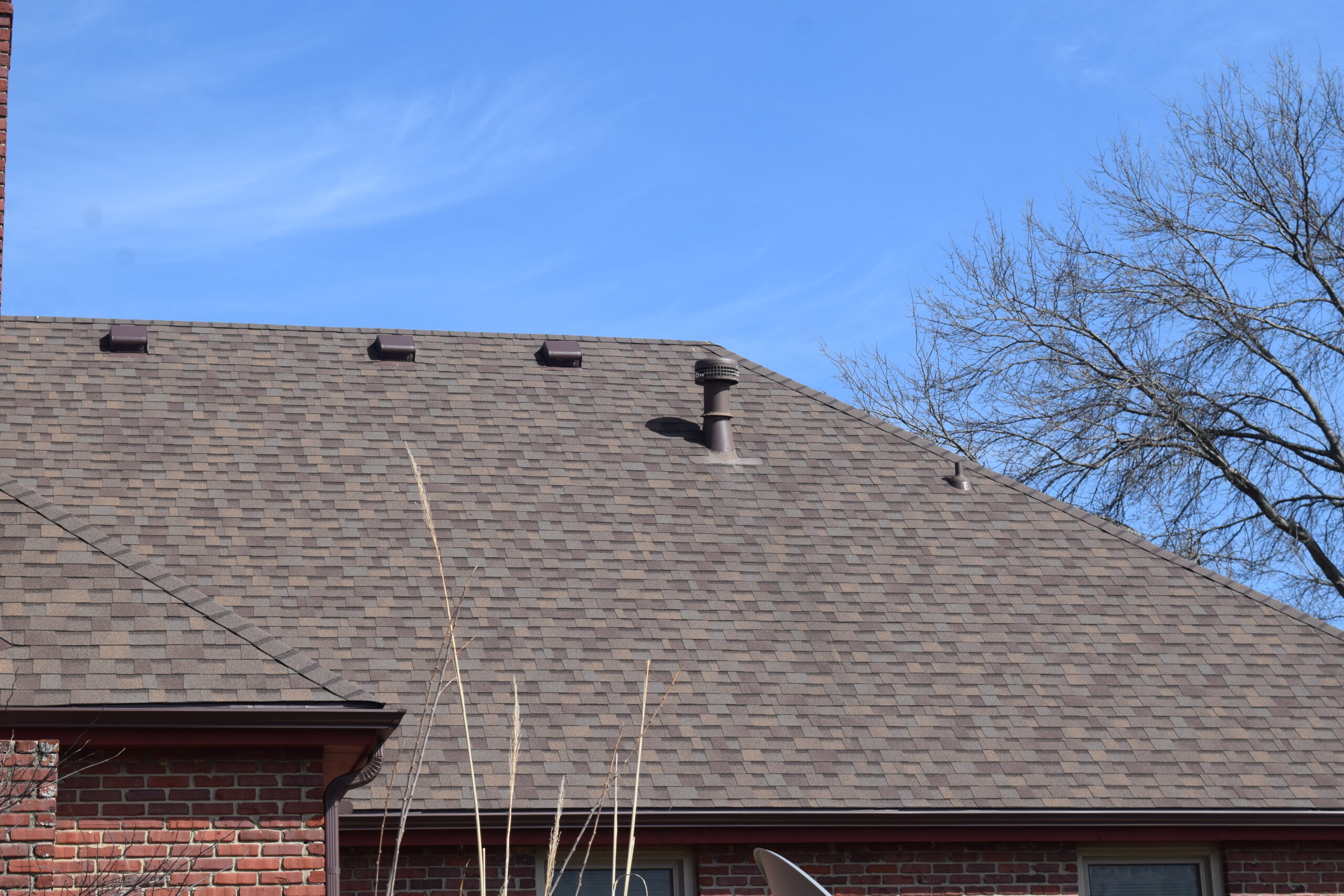 view of roof ventilation system on a roof with asphalt shingles, blue sky in background in Golden, CO