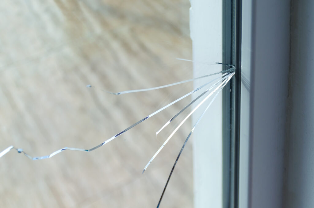Crack on the glass of a window at a residential house. 