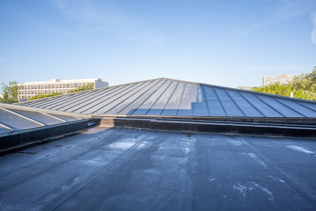 commercial roof hail damage on a black commercial roof after a hail storm in Denver Colorado
