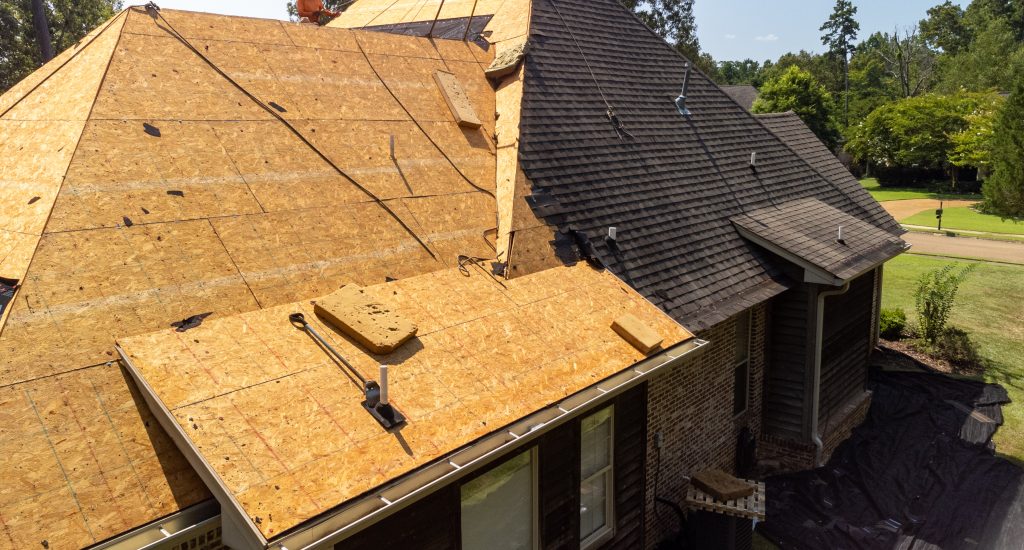 House with new roof being installed after hail damage to make a more energy efficient home